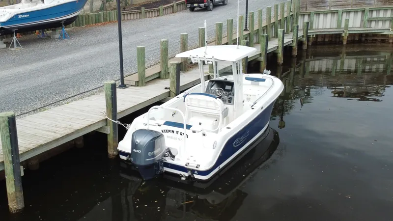 Slide: The Image of 2020 Robalo R242 Explorer boat docked at a marina. - 20