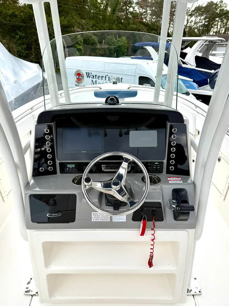 Slide: The Image of 2020 Robalo R242 Explorer boat dashboard with steering wheel and navigation controls. - 21
