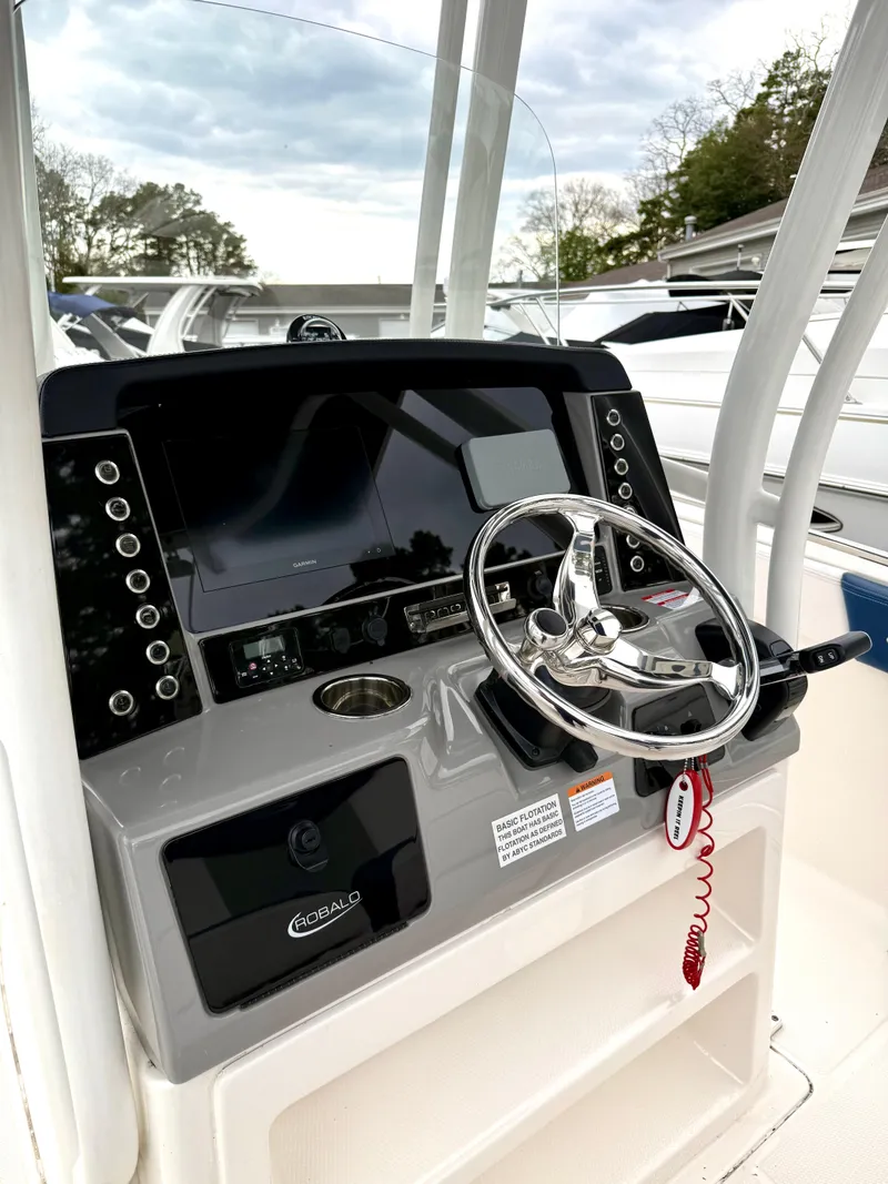 Slide: The Image of 2020 Robalo R242 Explorer boat dashboard with steering wheel and control panel. - 22