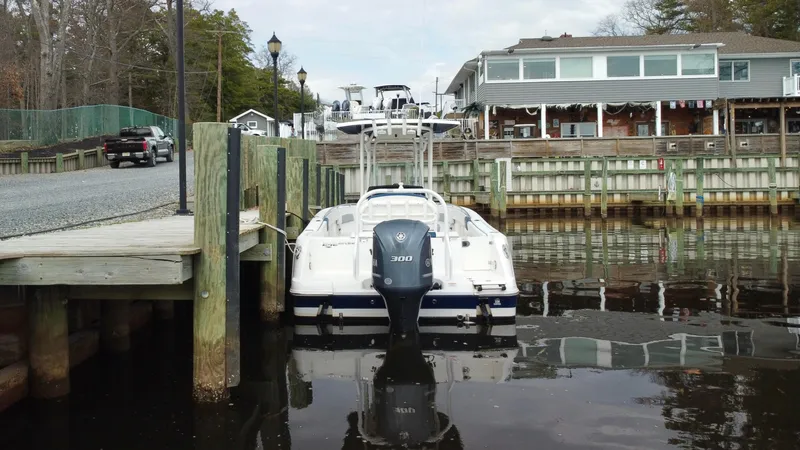 Slide: The Image of 2020 Robalo R242 Explorer docked at a marina with waterfront buildings. - 4