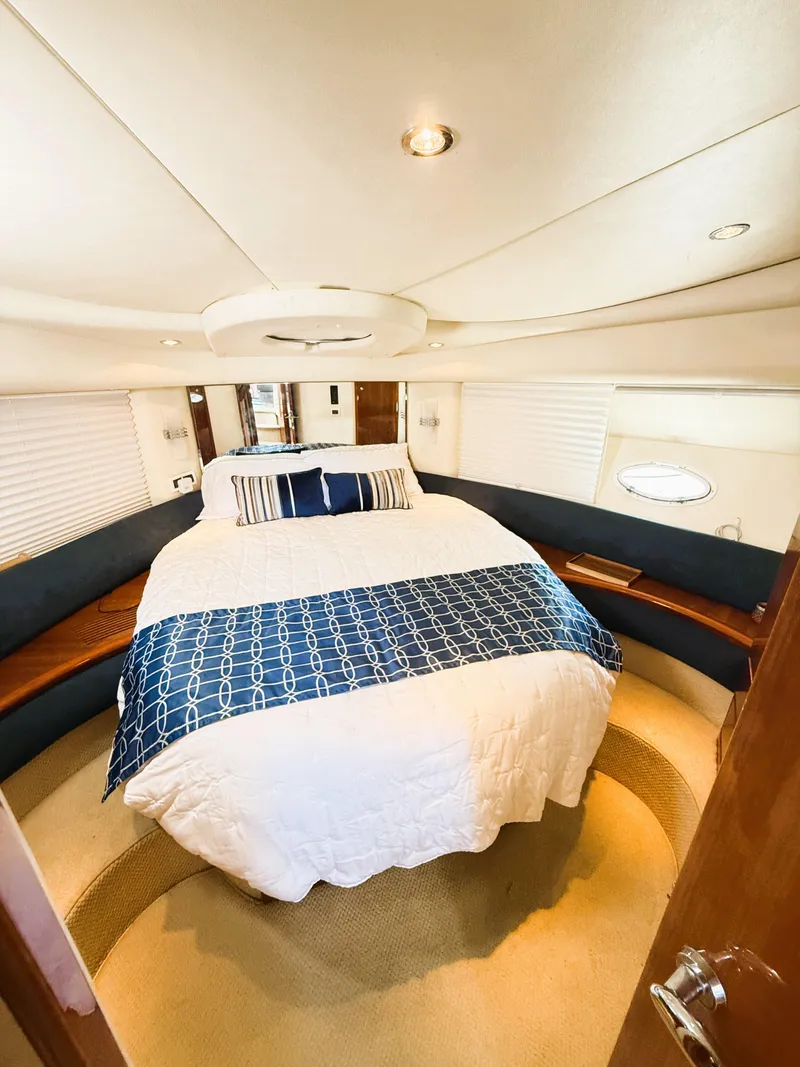 Slide: The Image of Luxurious bedroom interior of a 2002 Azimut 42 yacht with elegant bedding and modern design. - 27