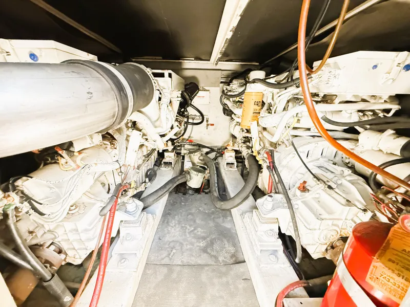 Slide: The Image of Engine room of a 2002 Azimut 42 yacht, showcasing dual engines and mechanical components. - 43