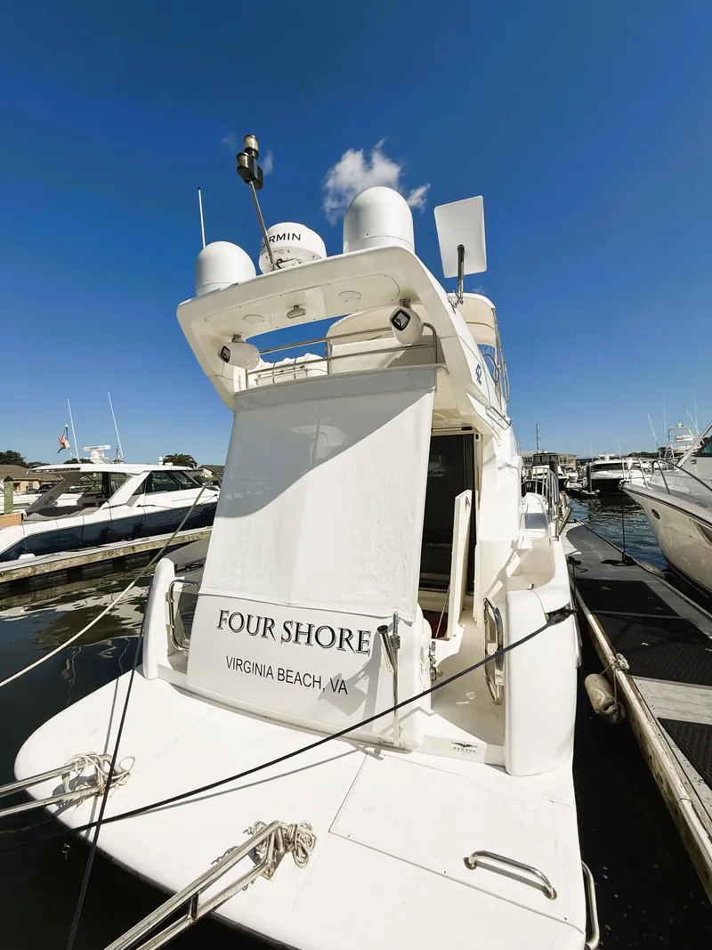 Slide: The Image of 2002 Azimut 42 yacht docked, named "Four Shore," in Virginia Beach marina. - 9