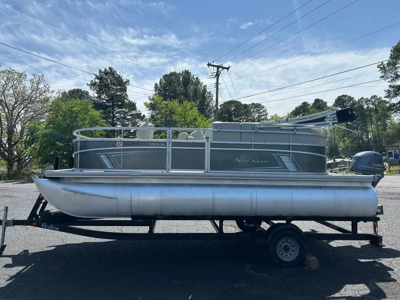 Slide: The Image of 2020 SunChaser Vista 18 Fish pontoon boat on trailer, parked outdoors. - 3