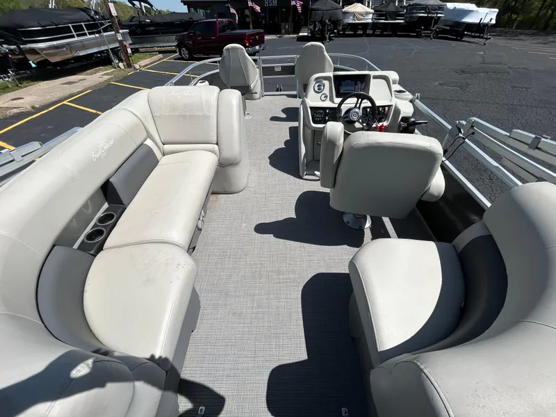 Slide: The Image of 2020 SunChaser Vista 18 Fish pontoon boat interior with spacious seating and modern dashboard. - 8