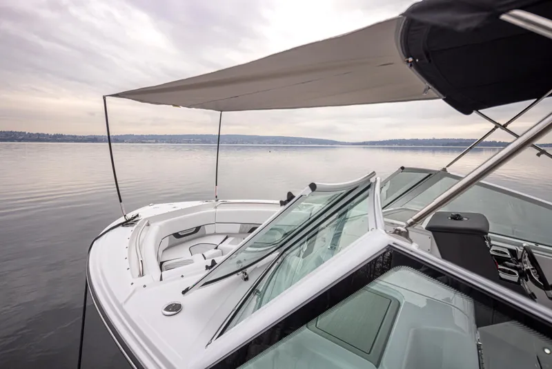 Slide: The Image of 2024 Blackfin 232DC Dual Console boat with canopy on calm water. - 33