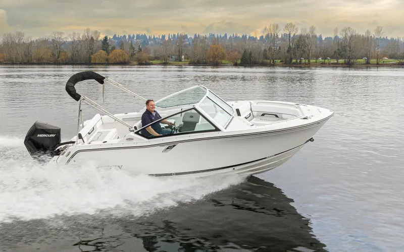 Slide: The Image of 2024 Blackfin 232DC Dual Console boat cruising on a calm lake. - 37