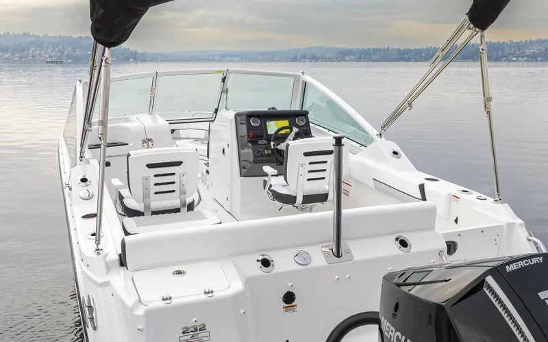 Slide: The Image of 2024 Blackfin 232DC Dual Console boat on calm water, featuring modern seating and controls. - 8