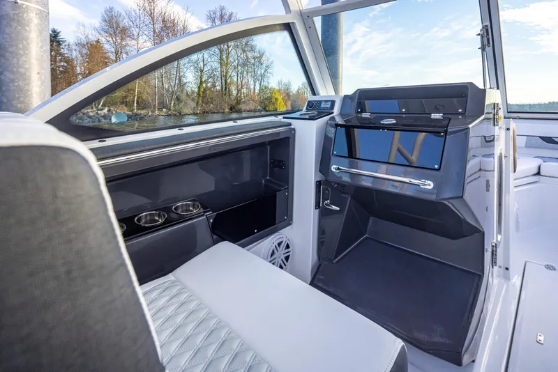 Slide: The Image of 2024 Blackfin 252 DC boat interior with modern dashboard and seating. - 15