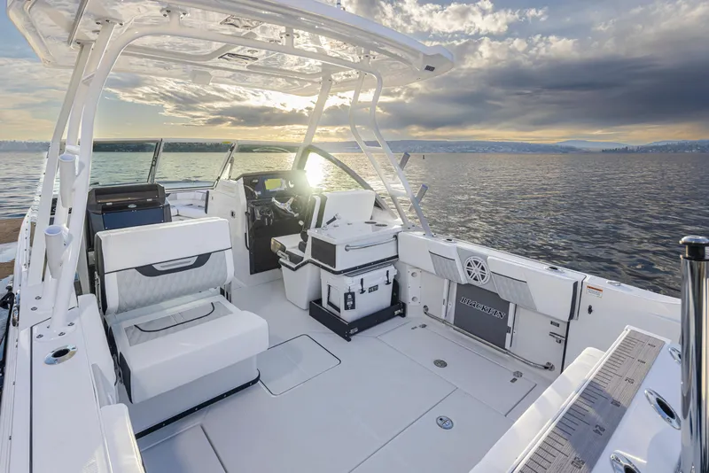 Slide: The Image of 2024 Blackfin 252 DC boat interior with seating, ocean view, and sunset. - 18