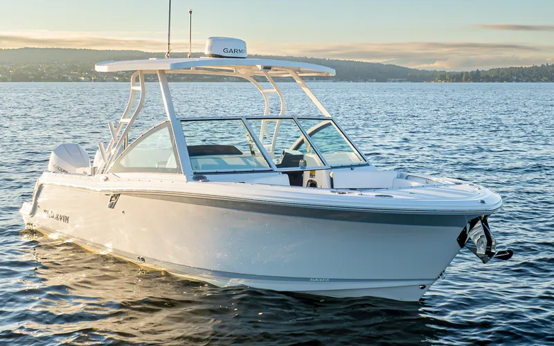 Slide: The Image of 2024 Blackfin 252 DC boat on calm water at sunset. - 2