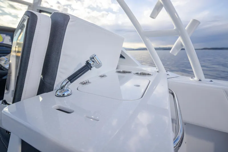 Slide: The Image of 2024 Blackfin 252 DC boat interior with sleek white console and ocean view. - 20