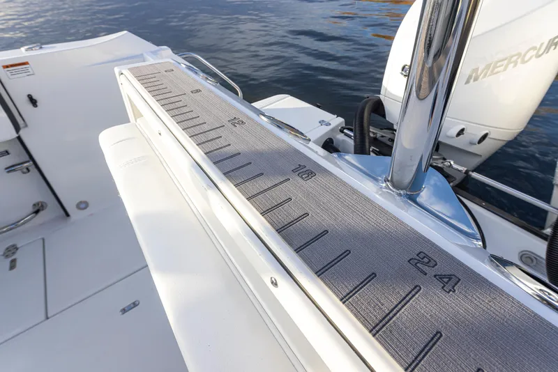 Slide: The Image of 2024 Blackfin 252 DC boat with a measuring ruler on deck near water. - 27