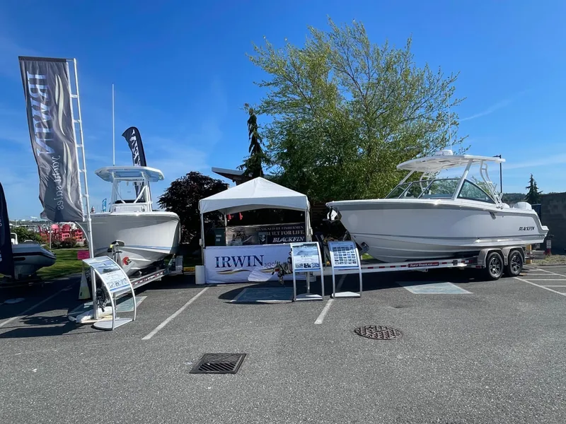 Slide: The Image of 2024 Blackfin 252 DC boats displayed outdoors at a boat show with promotional banners. - 39