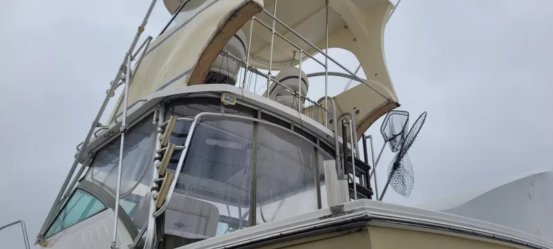 Slide: The Image of 2006 Wellcraft 330 Coastal boat with canopy and fishing gear, viewed from below. - 12