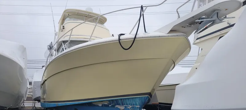 Slide: The Image of 2006 Wellcraft 330 Coastal boat in dry dock, viewed from the front. - 2