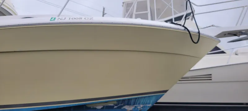 Slide: The Image of 2006 Wellcraft 330 Coastal boat docked, showcasing sleek design and sturdy build. - 4