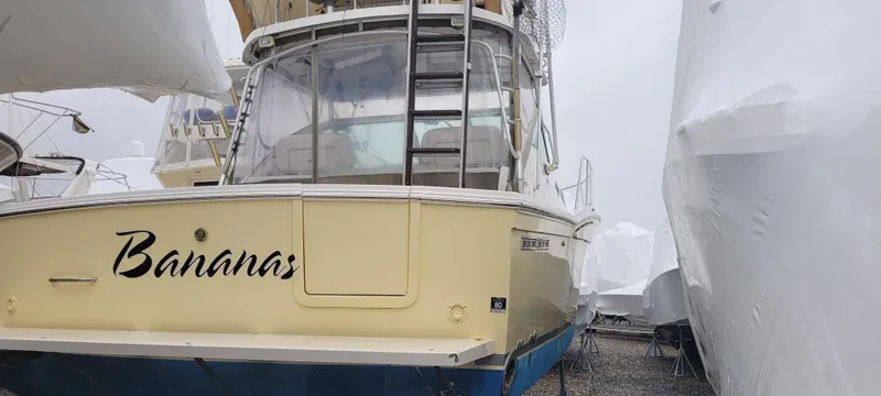 Slide: The Image of 2006 Wellcraft 330 Coastal boat named "Bananas" in storage, rear view. - 7