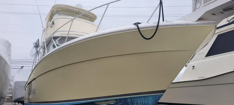 Slide: The Image of 2006 Wellcraft 330 Coastal boat docked, showcasing sleek design and sturdy build. - 9