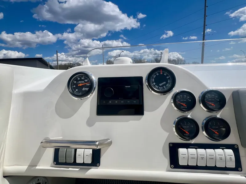 Slide: The Image of Instrument panel of a 2001 Skater 32B boat under a partly cloudy sky. - 11