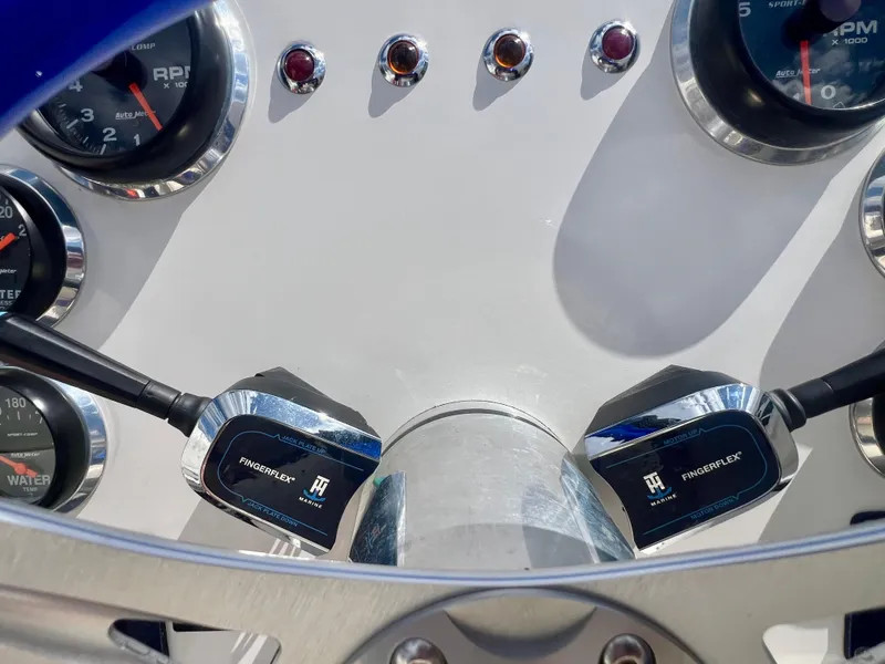 Slide: The Image of Dashboard of a 2001 Skater 32B boat with gauges and controls. - 14