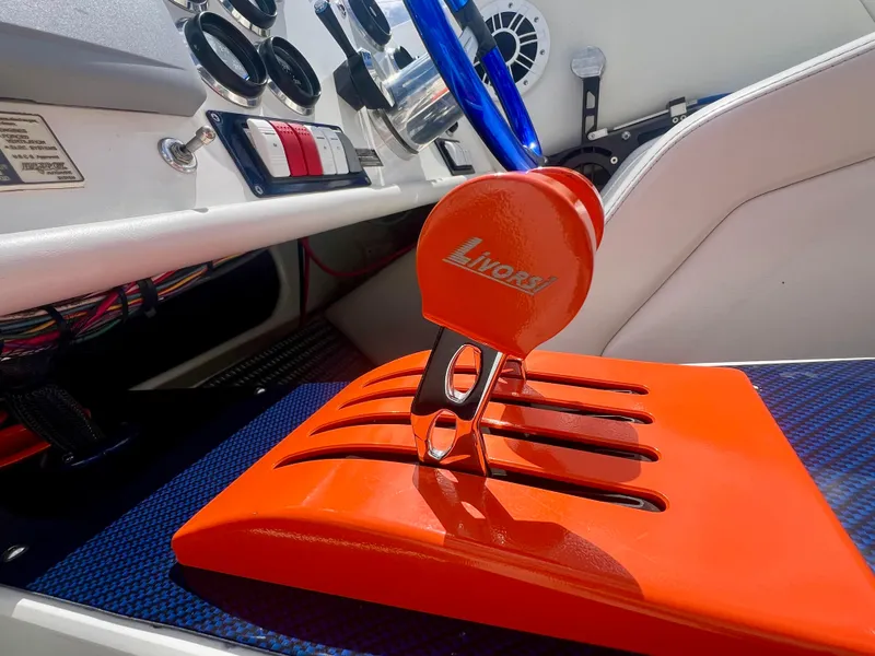 Slide: The Image of Orange throttle control in a 2001 Skater 32B boat cockpit, featuring Livorsi branding. - 17