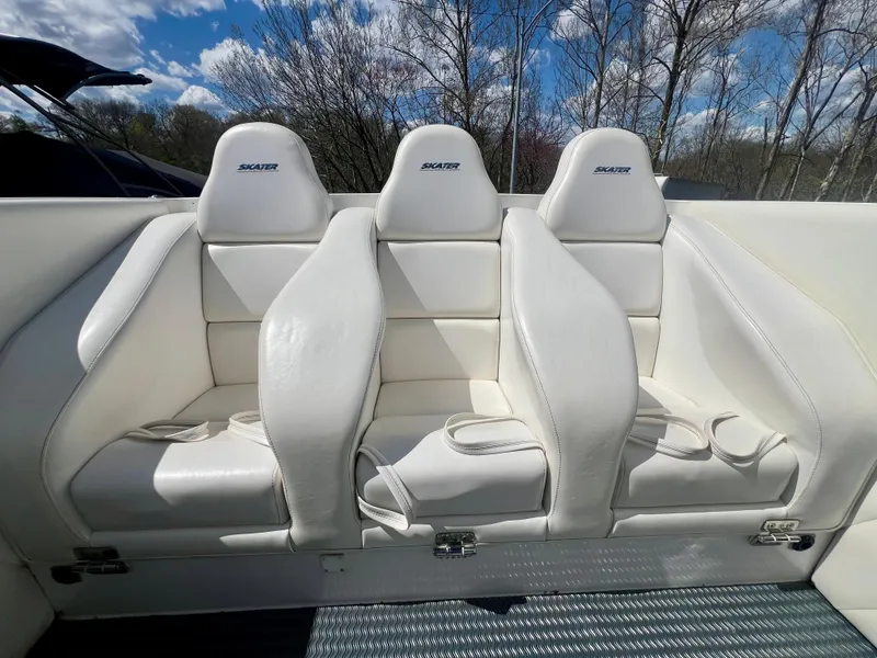 Slide: The Image of White Skater 32B boat seats, 2001 model, under a clear blue sky. - 20