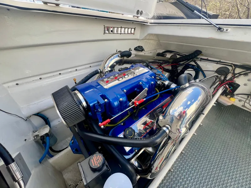 Slide: The Image of Engine compartment of a 2001 Skater 32B boat, featuring a blue high-performance engine. - 24