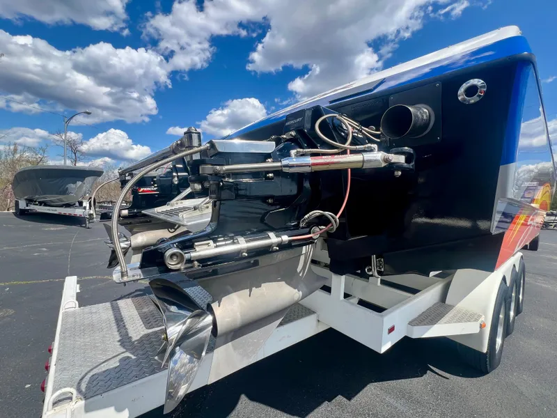 Slide: The Image of 2001 Skater 32B boat on trailer under a blue sky with clouds. - 25