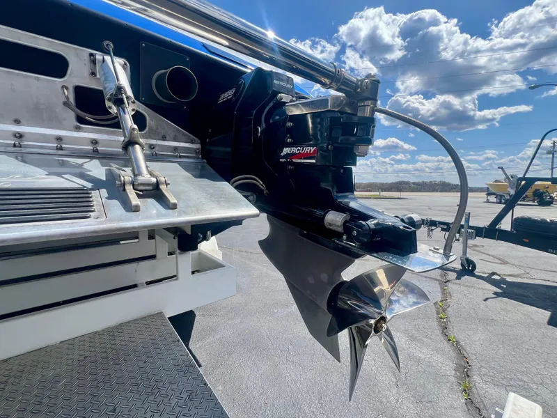 Slide: The Image of Rear view of a 2001 Skater 32B boat with Mercury engine under a sunny sky. - 26