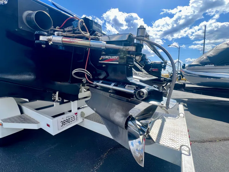 Slide: The Image of Rear view of a 2001 Skater 32B boat with Mercury engine on a trailer. - 27