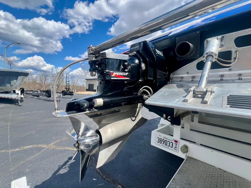 Slide: The Image of Close-up of a Skater 32B boat's propeller and stern, under a blue sky. - 28