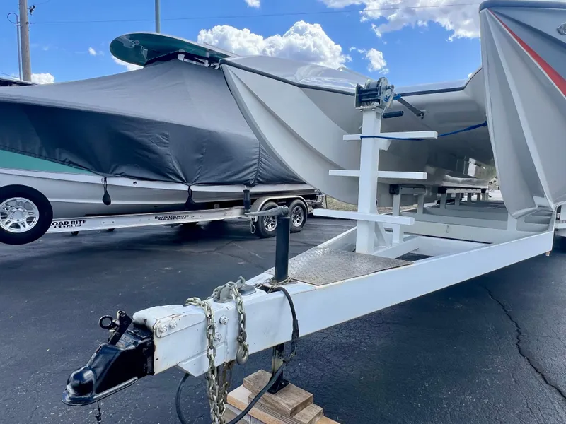 Slide: The Image of Boat trailer with Skater 32B, 2001 model, parked on asphalt under a cloudy sky. - 29