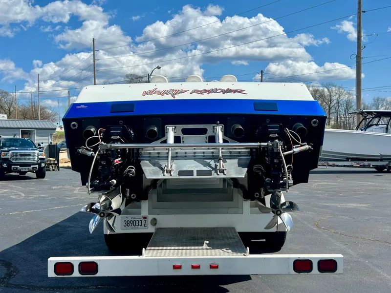 Slide: The Image of Rear view of a 2001 Skater 32B boat with dual engines, parked outdoors. - 3