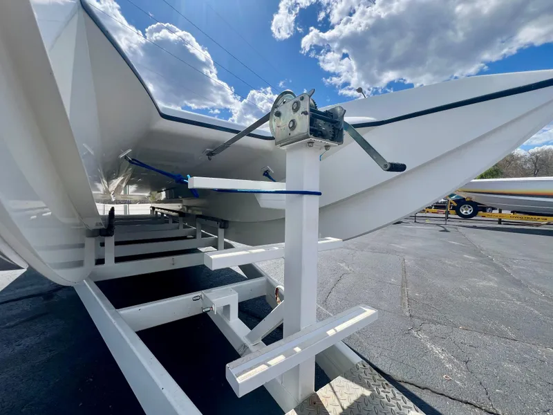 Slide: The Image of 2001 Skater 32B boat on trailer under cloudy sky. - 31