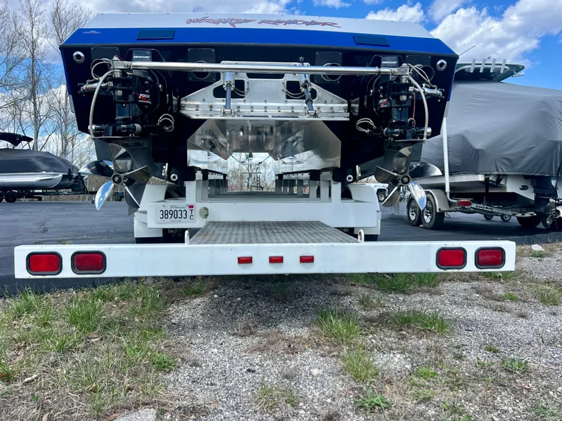 Slide: The Image of Rear view of a 2001 Skater 32B boat on a trailer, showcasing dual propellers. - 33