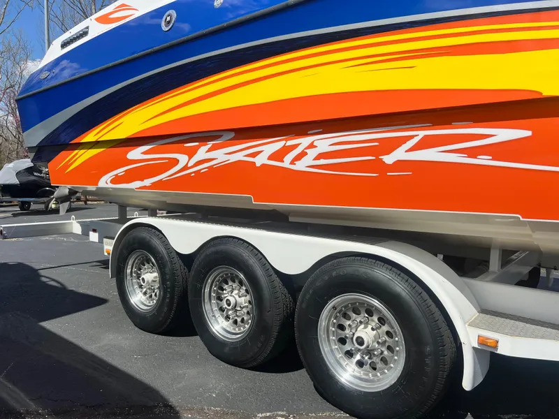 Slide: The Image of Colorful Skater 32B speedboat on trailer, vibrant design, 2001 model. - 34