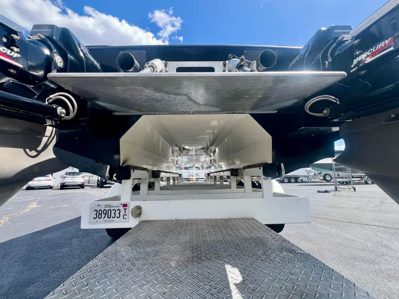 Slide: The Image of Rear view of a 2001 Skater 32B boat on a trailer, showcasing dual engines. - 4