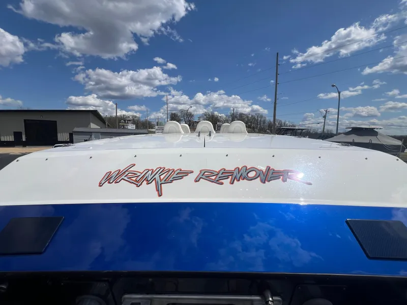 Slide: The Image of Skater 32B boat with "Wrinkle Remover" text, under a partly cloudy sky. - 5