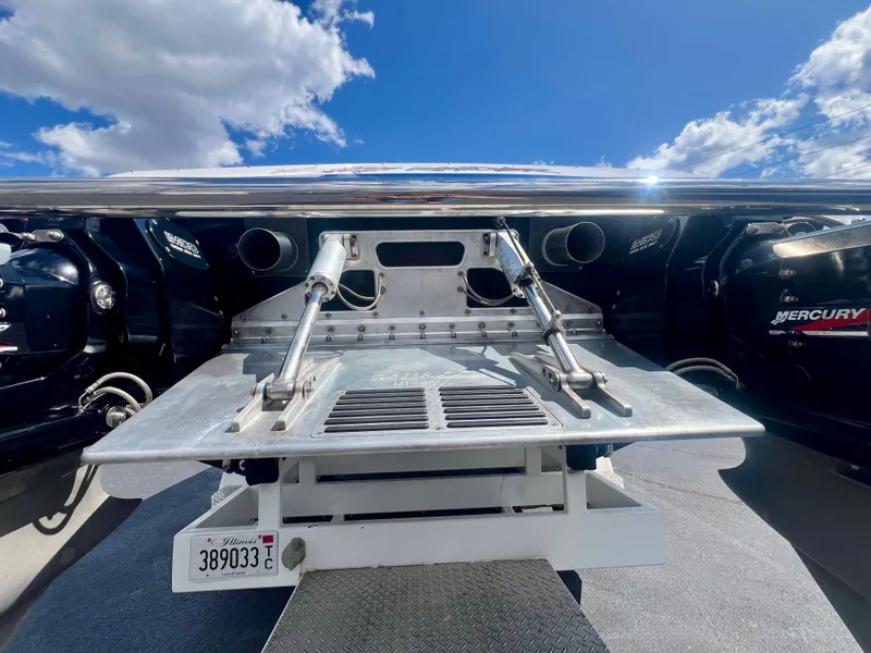 Slide: The Image of Rear view of a 2001 Skater 32B boat with Mercury engines under a blue sky. - 7