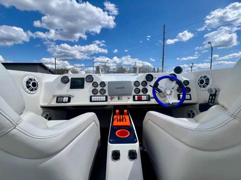 Slide: The Image of Interior of a 2001 Skater 32B boat with modern dashboard and blue steering wheel. - 8