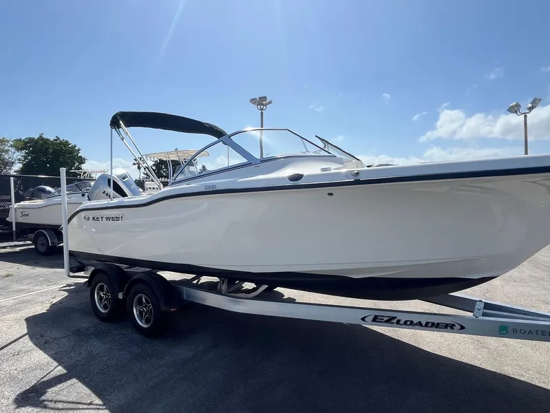 Slide: The Image of 2022 Key West 239 DFS boat on trailer under clear blue sky. - 3