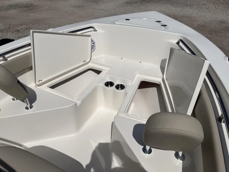 Slide: The Image of 2025 Key West 203 FS boat interior with open storage compartments and cup holders. - 10