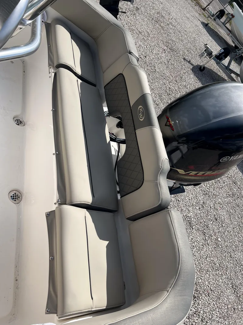 Slide: The Image of 2025 Key West 203 FS boat interior with cushioned seating and outboard motor. - 16