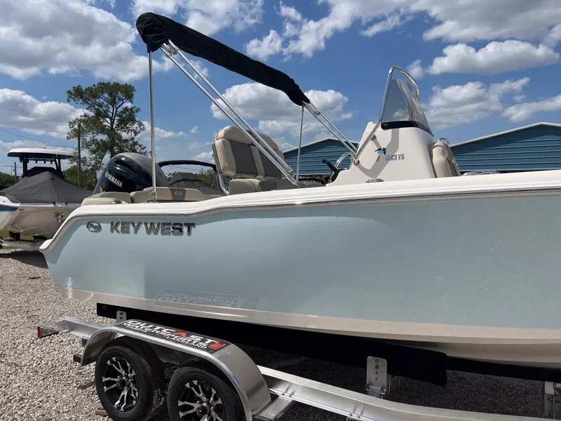 Slide: The Image of 2025 Key West 203 FS boat on trailer under blue sky with clouds. - 3