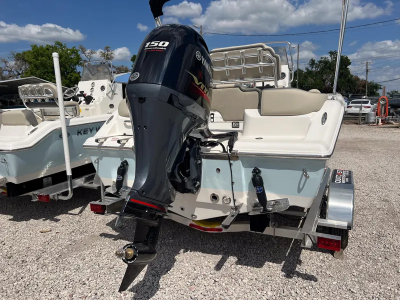 Slide: The Image of 2025 Key West 203 FS boat with outboard motor on trailer, parked outdoors. - 4