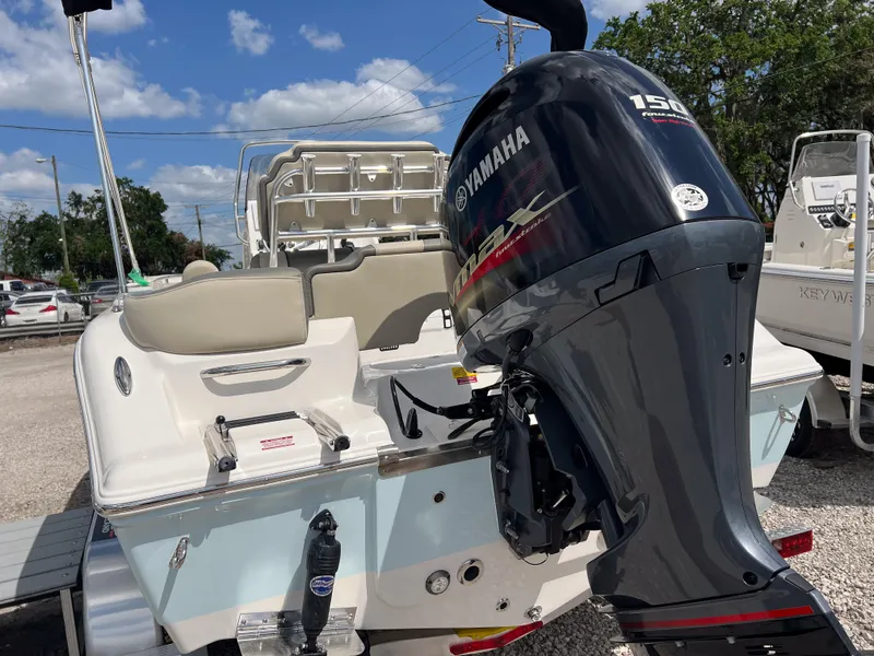 Slide: The Image of 2025 Key West 203 FS boat with Yamaha 150 engine, parked outdoors. - 5