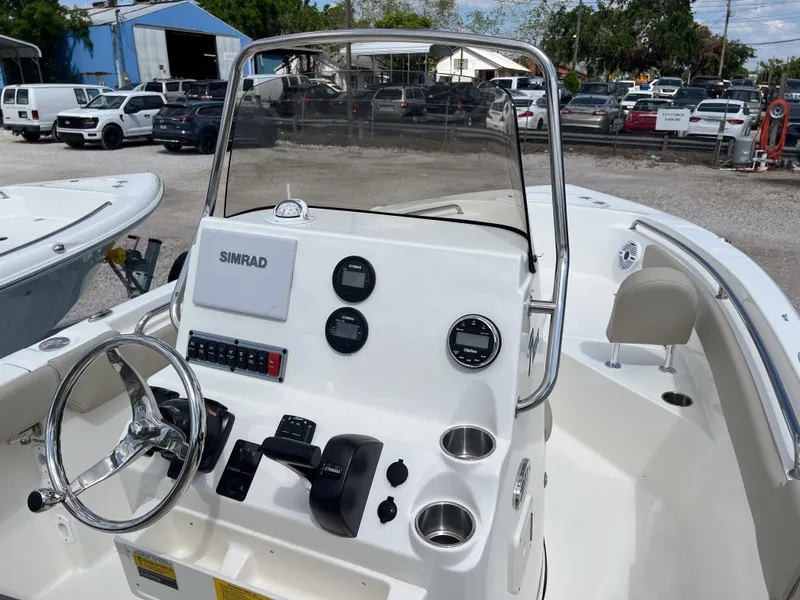 Slide: The Image of 2025 Key West 203 FS boat dashboard with steering wheel and navigation controls. - 7