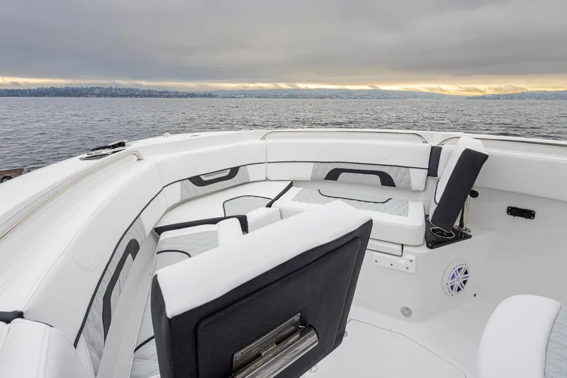 Slide: The Image of 2024 Blackfin 222 CC boat interior with white seating, overlooking a serene water view. - 25