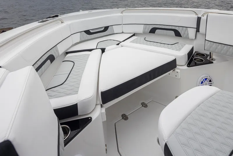 Slide: The Image of 2024 Blackfin 222 CC boat interior with luxurious white seating and cup holders. - 27